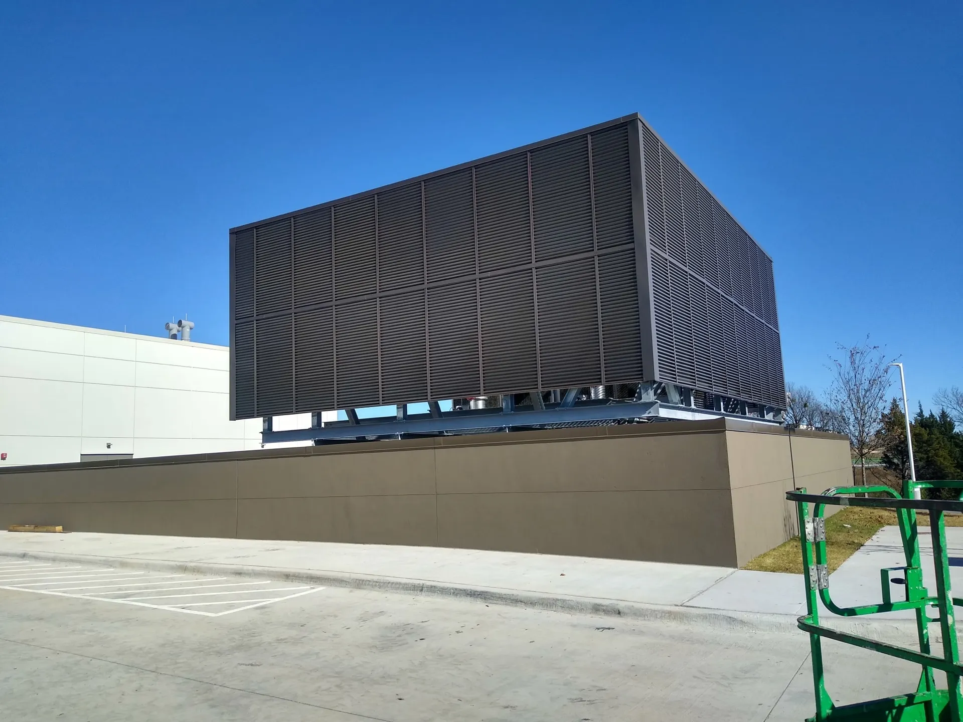 Bronze louvered mechanical equipment screen on a steel base