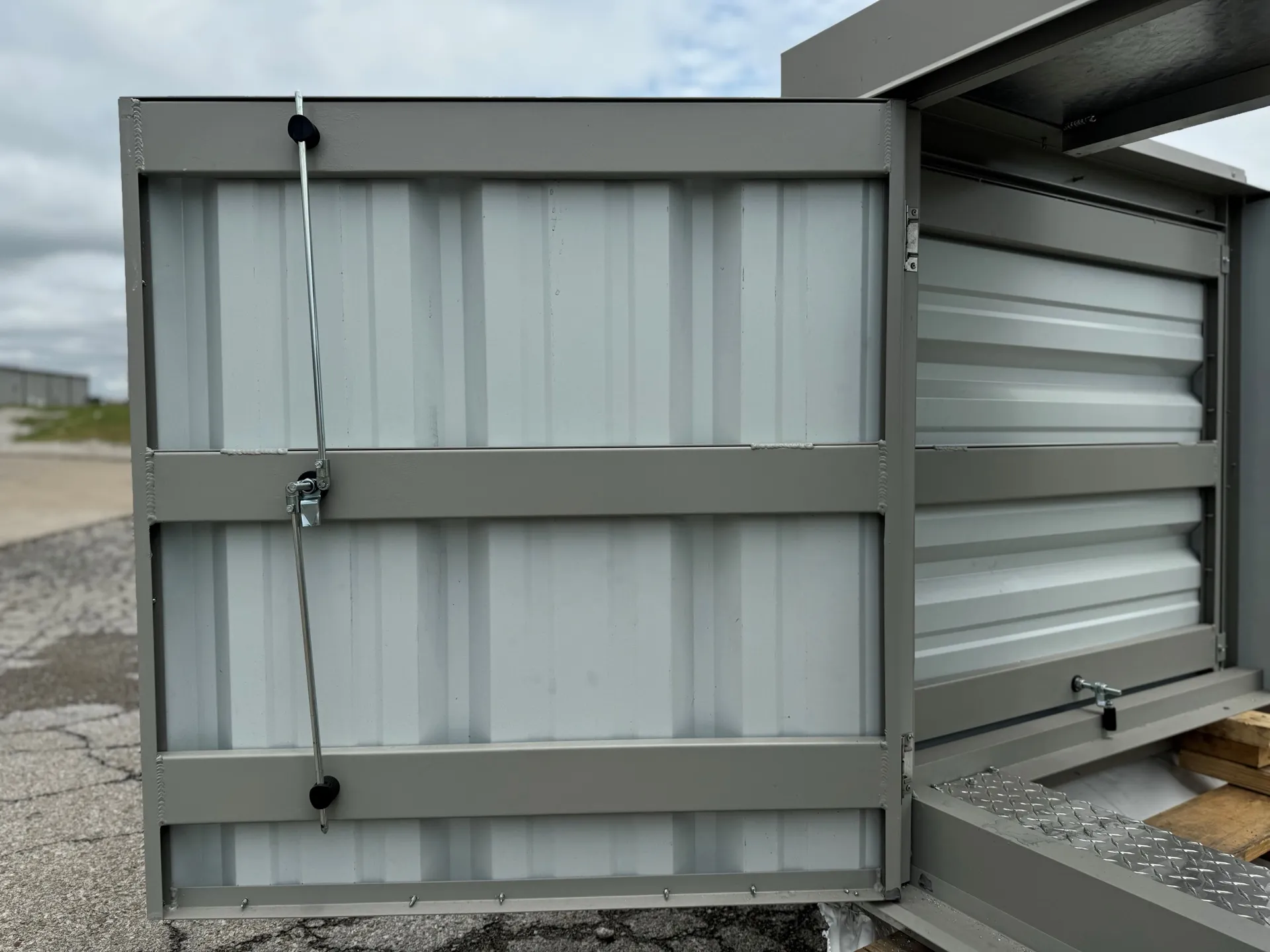 Open RTU screen access door showing corrugated panels and locking hardware