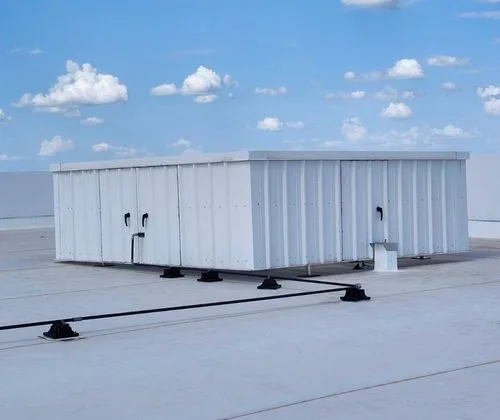 White corrugated steel RTU screen enclosure on a flat commercial roof